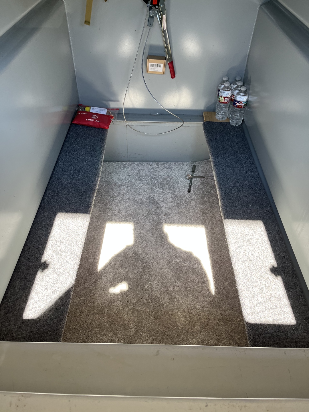 Professionally cleaned storm shelter interior with first aid kit and water bottles