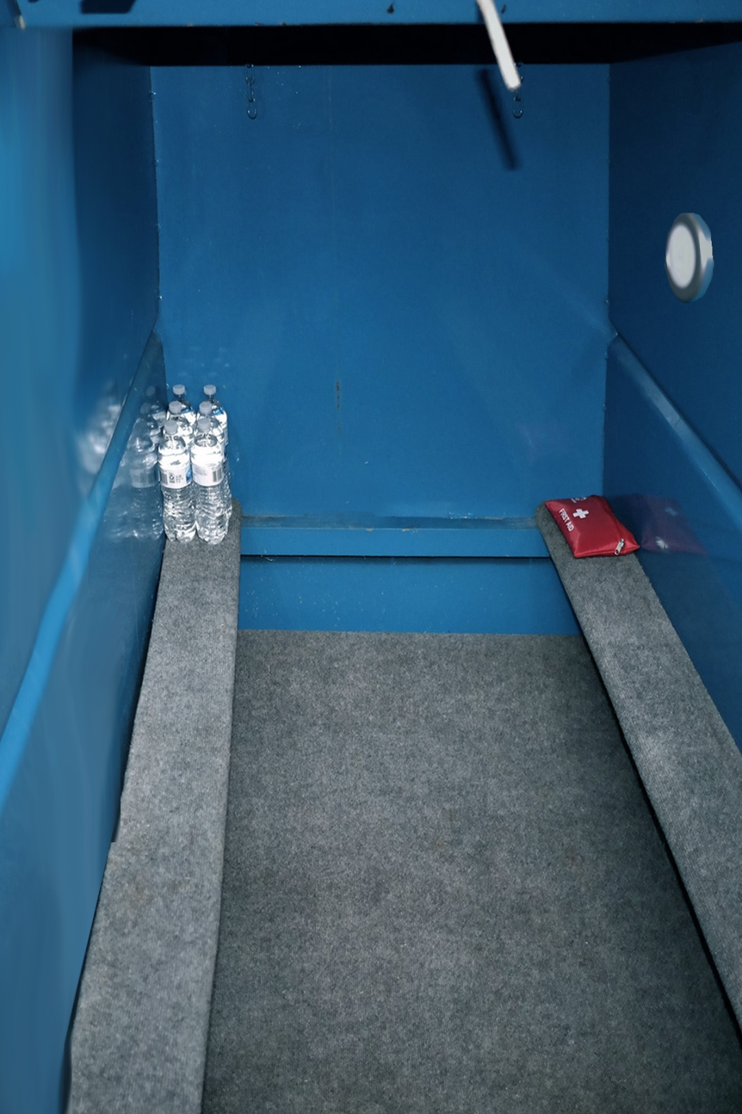Storm shelter interior after cleaning — spotless, fresh water and first aid kit stocked